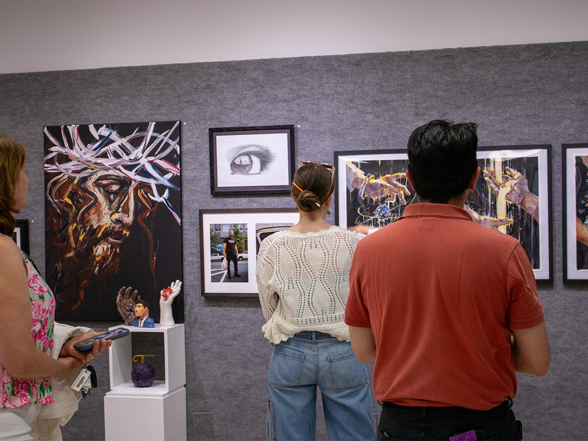 people looking at art on display for art show at college