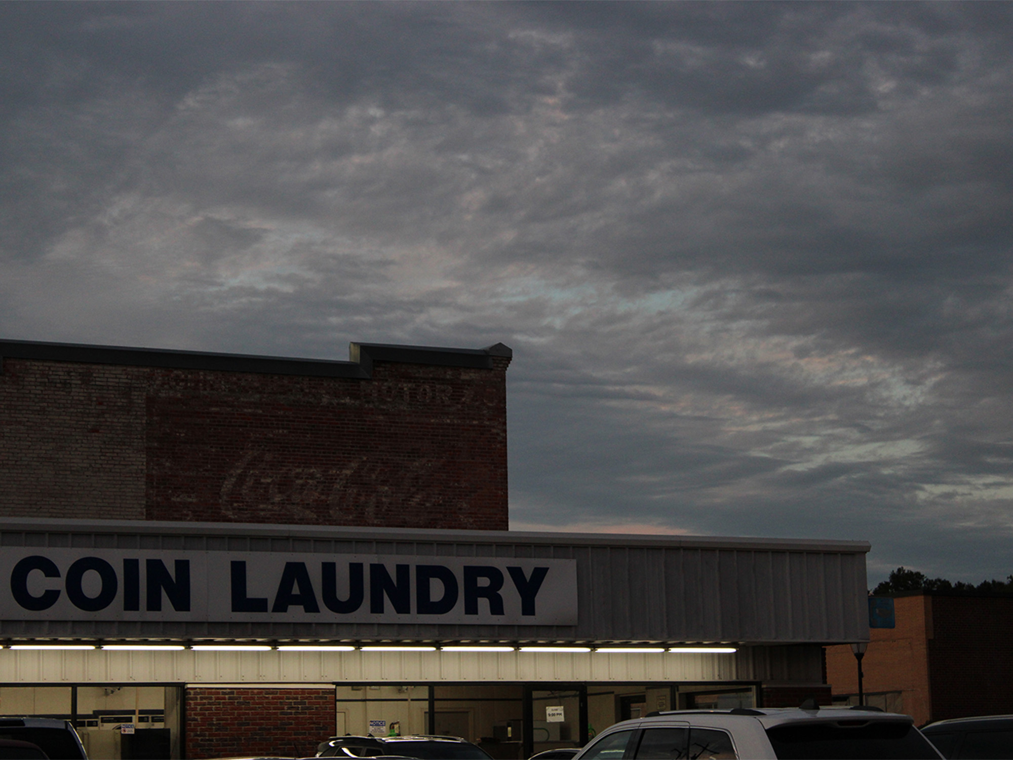 Coin Laundry mat sign at sunset