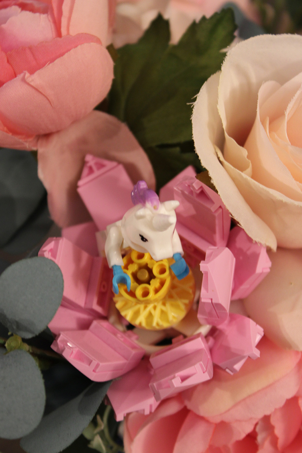 lego unicorn in lego flower that is in bouquet of flowers