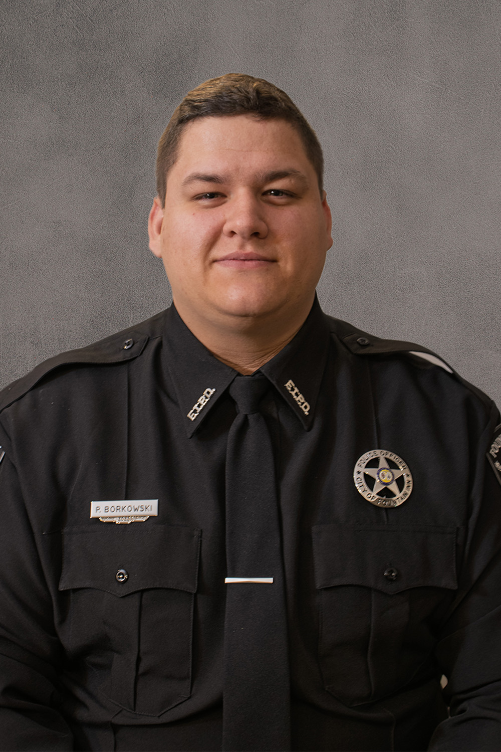portrait of police officer in class a uniform smiling